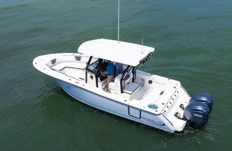 Slide: The Image of 2023 Robalo R270 Center Console boat on water, featuring dual Yamaha engines. - 14