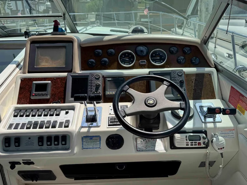 Slide: The Image of 1995 Sea Ray 400 Express Cruiser dashboard with steering wheel and navigation controls. - 12
