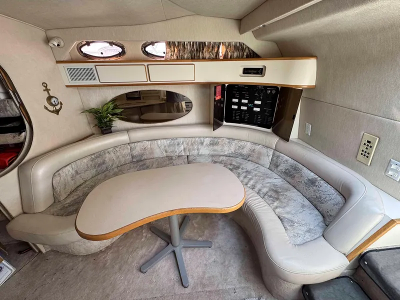 Slide: The Image of Interior of 1995 Sea Ray 400 Express Cruiser with curved seating and table. - 18