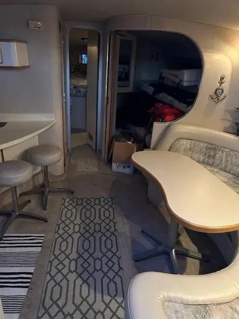 Slide: The Image of Interior of a 1995 Sea Ray 400 Express Cruiser with seating and dining area. - 21