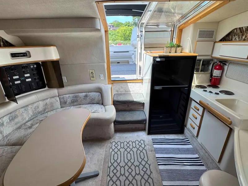 Slide: The Image of Interior of a 1995 Sea Ray 400 Express Cruiser with kitchen and seating area. - 22
