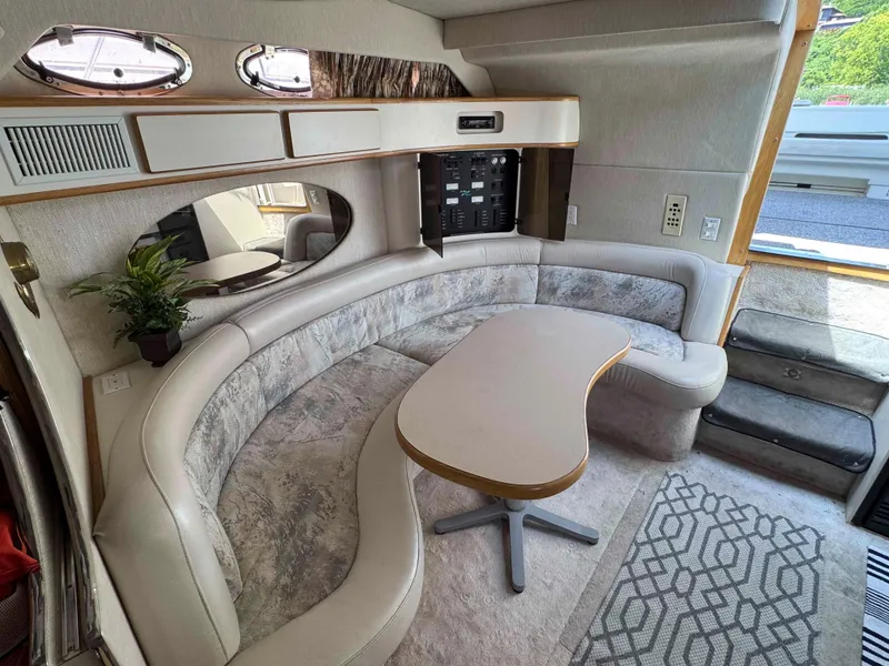 Slide: The Image of Interior of 1995 Sea Ray 400 Express Cruiser with curved seating and table. - 23