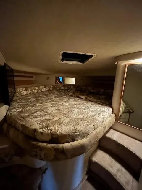 Slide: The Image of Interior cabin of 1995 Sea Ray 400 Express Cruiser with a cozy bed and steps. - 26
