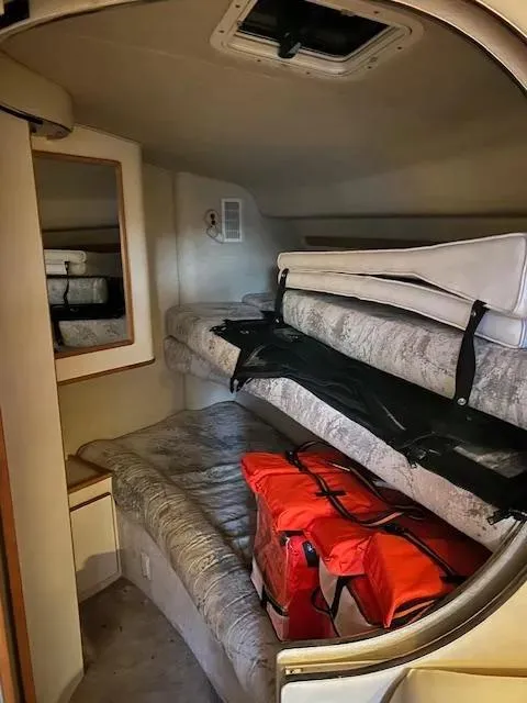 Slide: The Image of Interior cabin of 1995 Sea Ray 400 Express Cruiser with bunk beds and storage. - 27