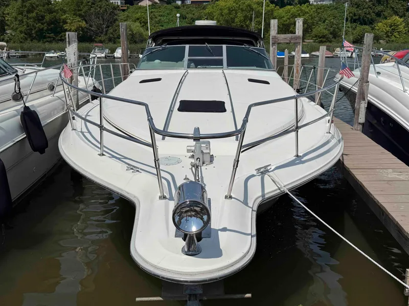 Slide: The Image of 1995 Sea Ray 400 Express Cruiser docked at marina, front view. - 3