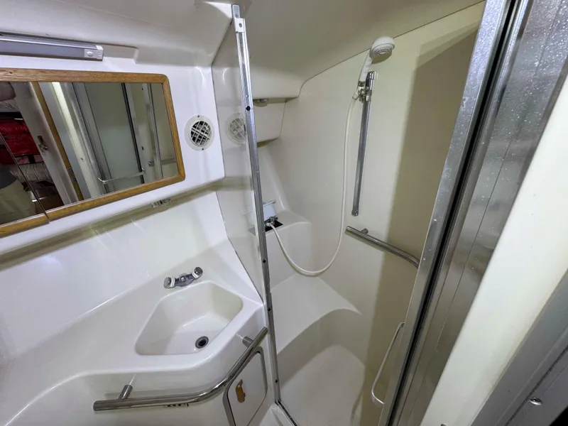 Slide: The Image of Bathroom interior of 1995 Sea Ray 400 Express Cruiser with shower and sink. - 30