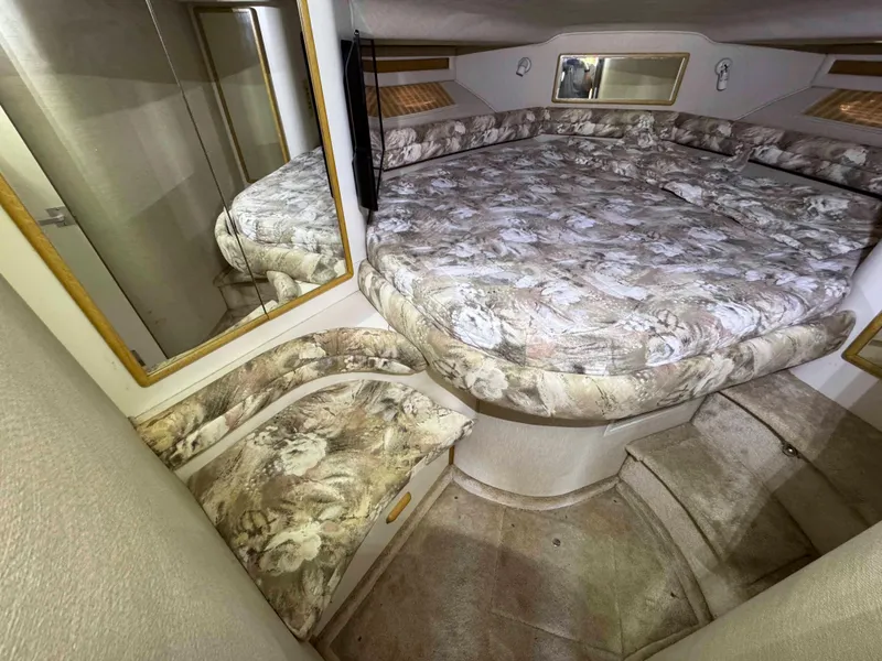 Slide: The Image of Interior cabin of 1995 Sea Ray 400 Express Cruiser with floral upholstery and mirrors. - 32