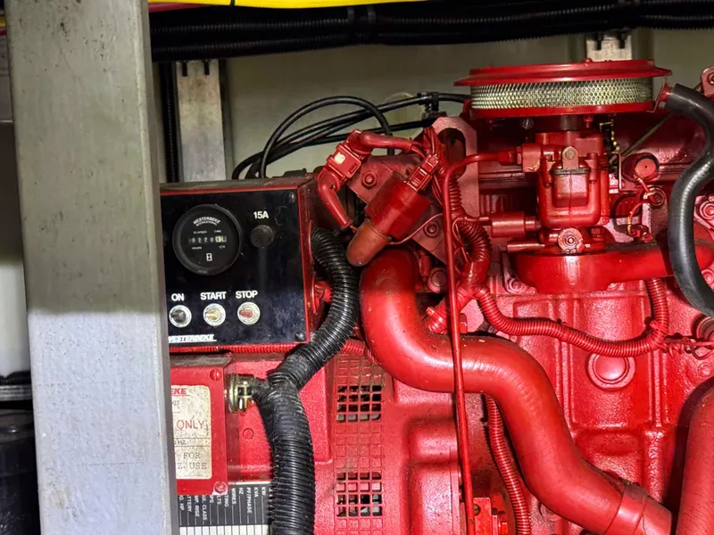 Slide: The Image of Engine compartment of a 1995 Sea Ray 400 Express Cruiser, featuring red mechanical components. - 33