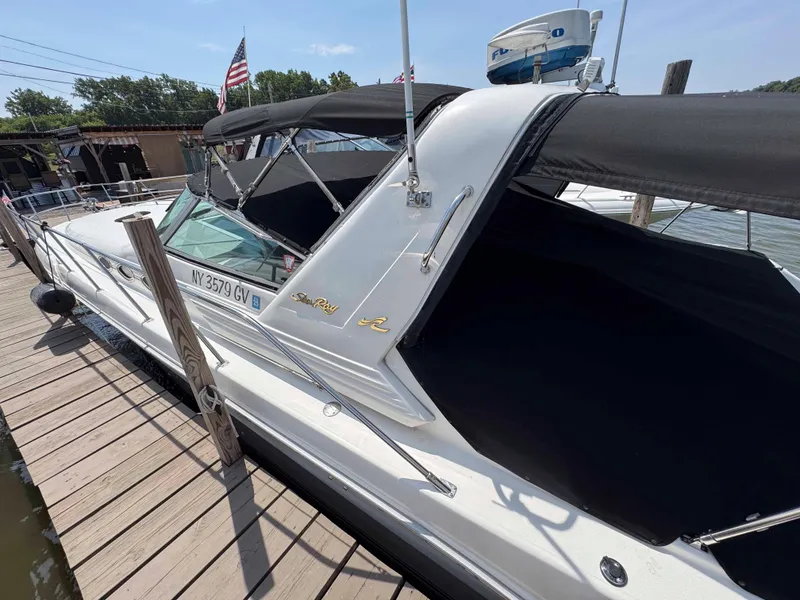 Slide: The Image of 1995 Sea Ray 400 Express Cruiser docked, featuring black canopy and sleek design. - 5