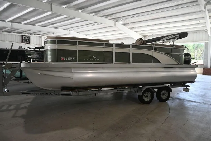 Slide: The Image of 2019 Bennington 22 SSR pontoon boat on trailer in indoor storage. - 1