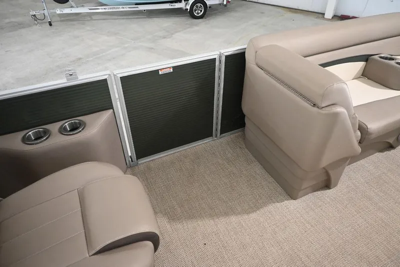 Slide: The Image of 2019 Bennington 22 SSR boat interior with beige seating and cup holders. - 11