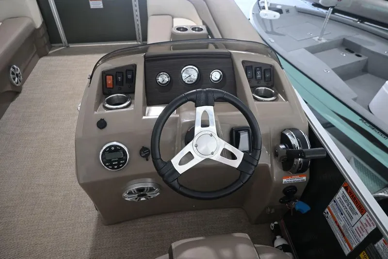Slide: The Image of 2019 Bennington 22 SSR boat dashboard with steering wheel and control panel. - 12