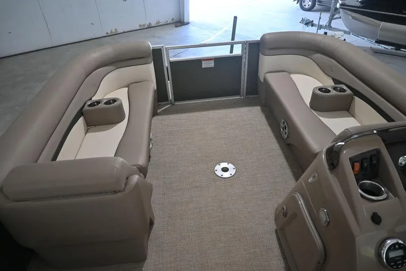 Slide: The Image of 2019 Bennington 22 SSR pontoon boat interior with beige seating and cup holders. - 13