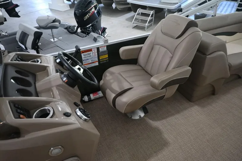 Slide: The Image of 2019 Bennington 22 SSR boat interior with captain's chair and steering console. - 14