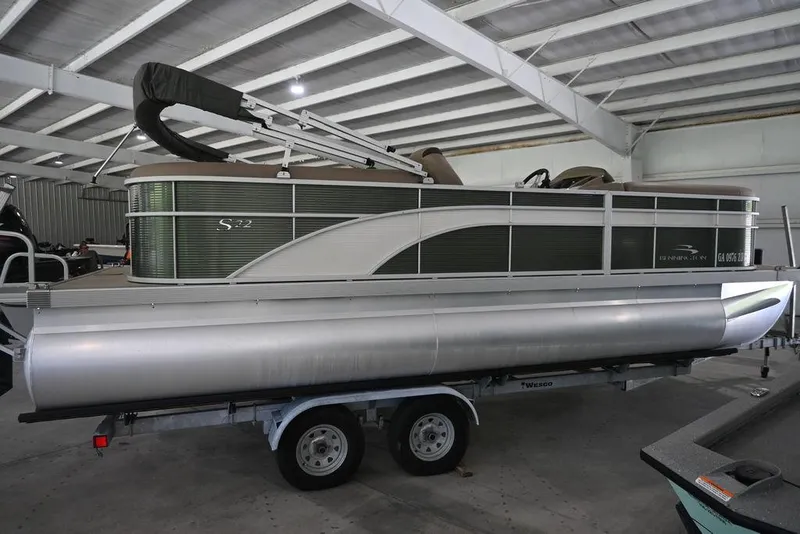 Slide: The Image of 2019 Bennington 22 SSR pontoon boat on trailer in indoor storage facility. - 2