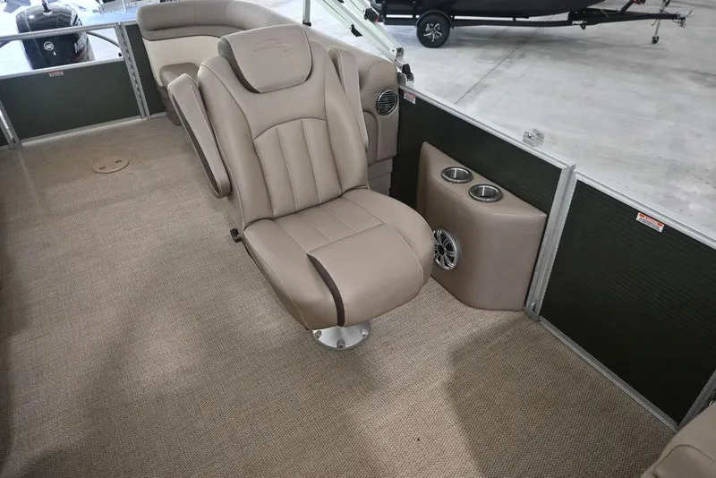 Slide: The Image of 2019 Bennington 22 SSR boat interior with beige seating and cup holders. - 4