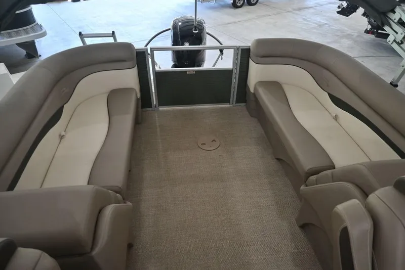 Slide: The Image of 2019 Bennington 22 SSR pontoon boat interior with beige seating and carpeted floor. - 9