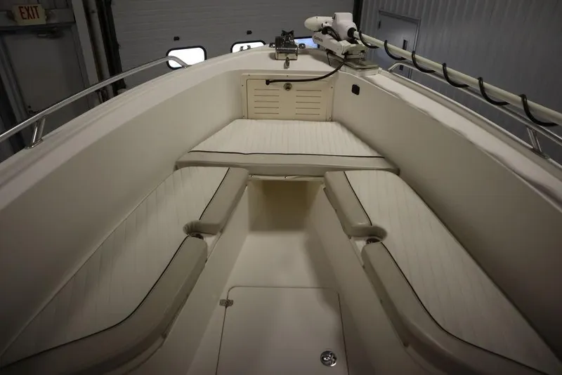 Slide: The Image of 2017 Mako 284 CC boat interior with cushioned seating and storage compartments. - 11