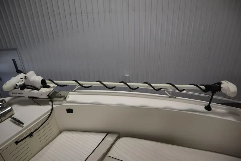 Slide: The Image of 2017 Mako 284 CC boat with Garmin trolling motor in a storage facility. - 12
