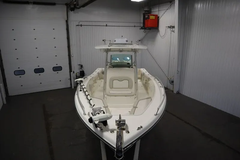 Slide: The Image of 2017 Mako 284 CC boat in a garage, front view. - 13