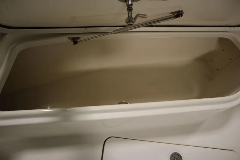 Slide: The Image of Open storage compartment on a 2017 Mako 284 CC boat. - 14
