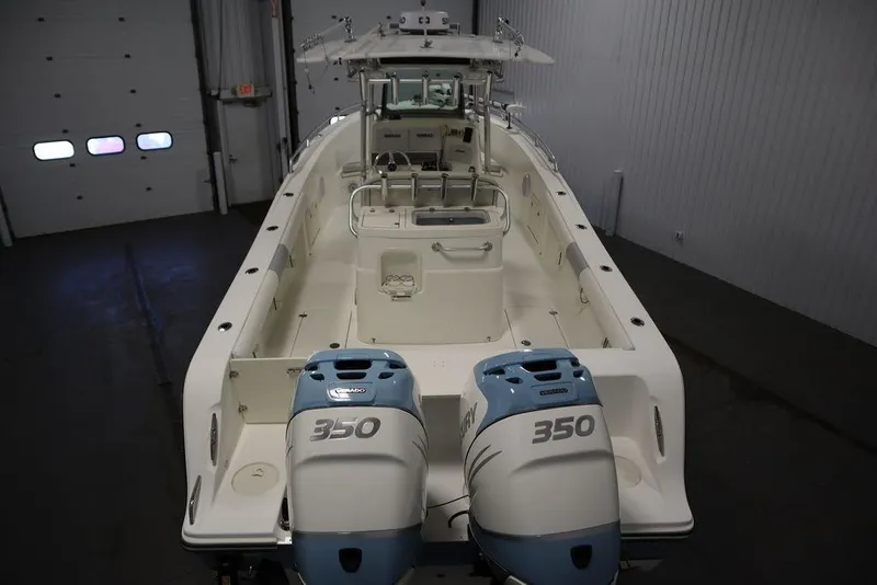 Slide: The Image of 2017 Mako 284 CC boat with dual 350 horsepower engines in a garage setting. - 18