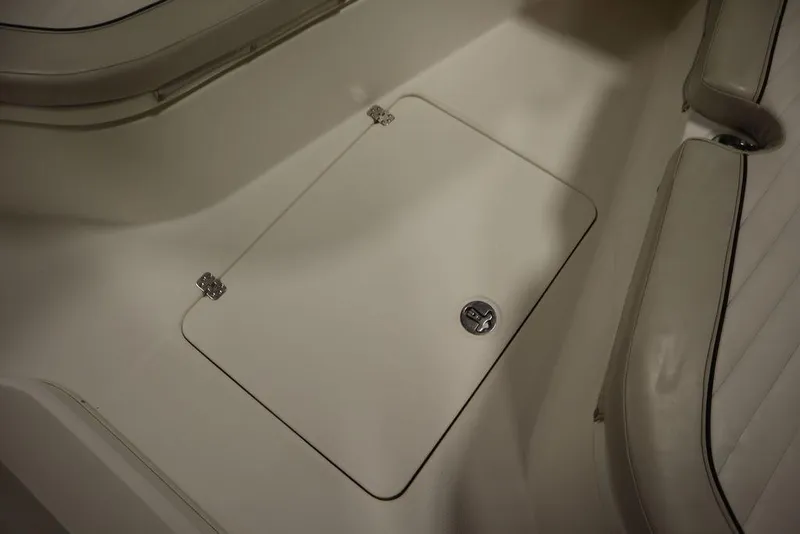 Slide: The Image of 2017 Mako 284 CC boat interior with storage compartment and seating. - 20