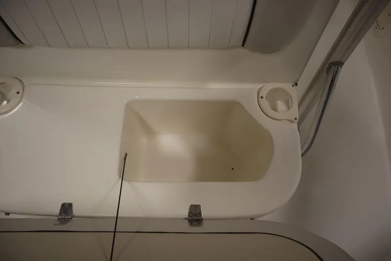 Slide: The Image of 2017 Mako 284 CC boat interior storage compartment with cup holders. - 22