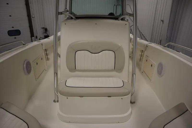Slide: The Image of 2017 Mako 284 CC boat interior with cushioned seating and storage compartments. - 24