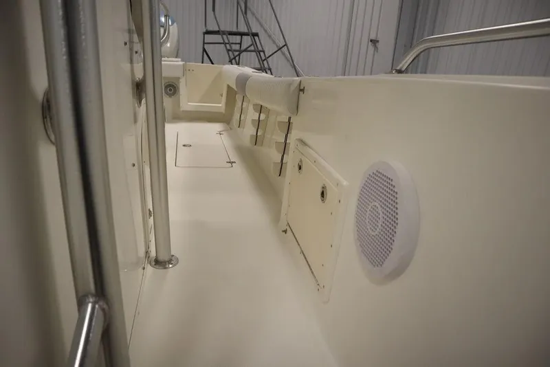 Slide: The Image of 2017 Mako 284 CC boat interior with speaker and storage compartments. - 25