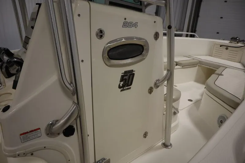 Slide: The Image of 2017 Mako 284 CC boat interior with seating and storage compartments. - 27