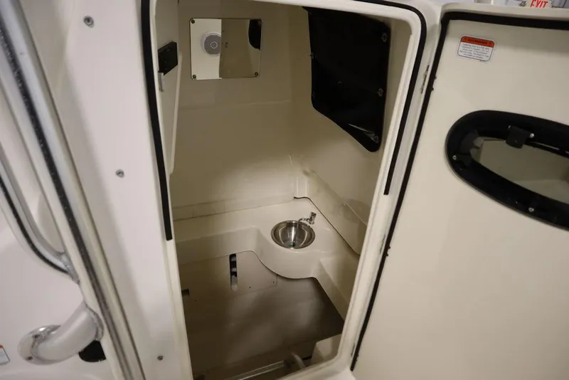 Slide: The Image of 2017 Mako 284 CC boat interior cabin with sink and storage. - 28