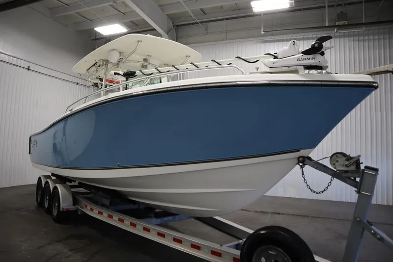 Slide: The Image of 2017 Mako 284 CC boat on trailer in indoor storage facility. - 3