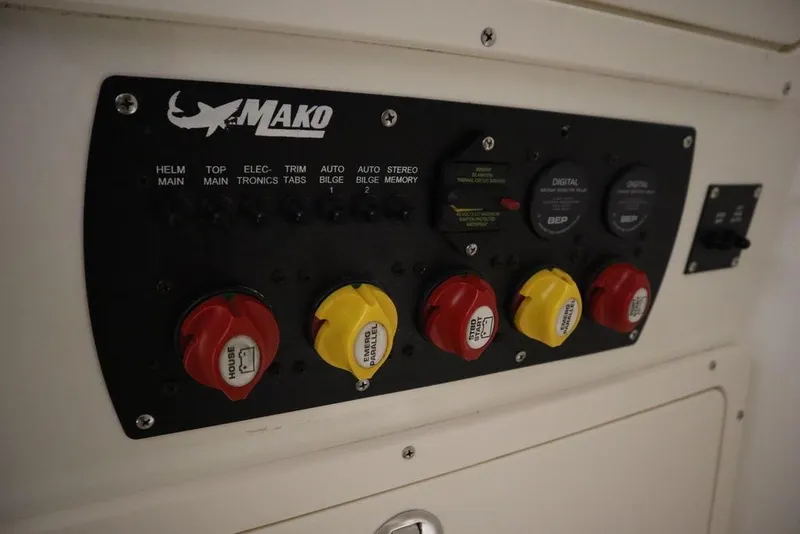Slide: The Image of Control panel of a 2017 Mako 284 CC boat with labeled switches and dials. - 30