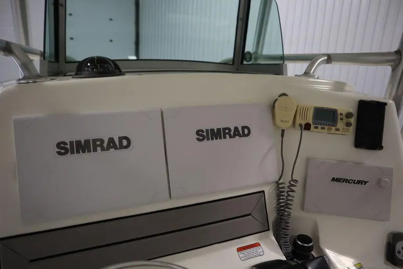 Slide: The Image of Control panel of 2017 Mako 284 CC boat with Simrad and Mercury equipment. - 34