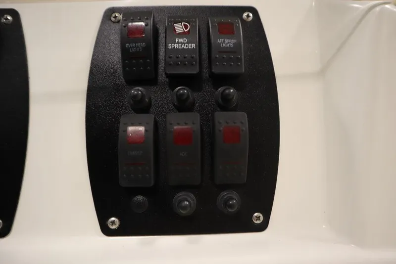 Slide: The Image of Control panel of a 2017 Mako 284 CC boat with labeled switches. - 35