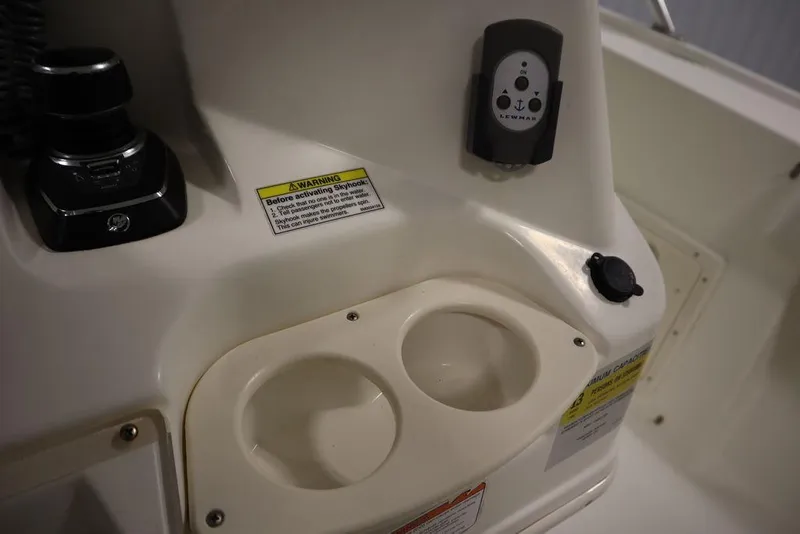 Slide: The Image of Control panel and cup holders on a 2017 Mako 284 CC boat. - 36