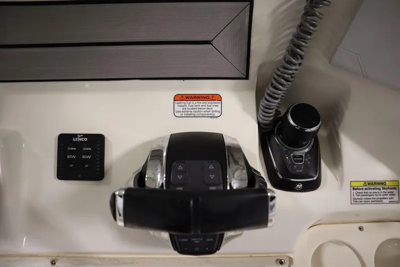 Slide: The Image of Control panel of a 2017 Mako 284 CC boat with joystick and trim tab controls. - 37