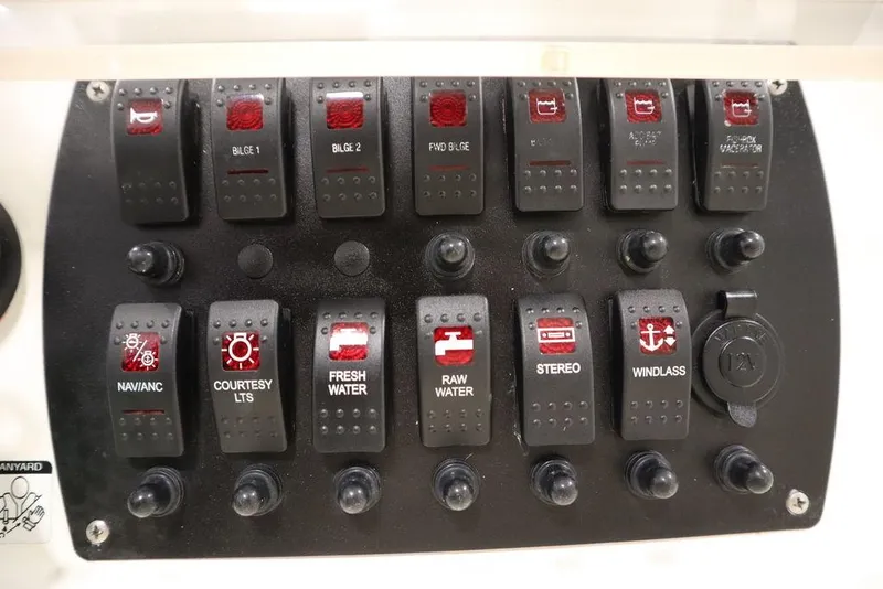 Slide: The Image of Control panel of a 2017 Mako 284 CC boat with labeled switches. - 38