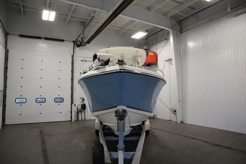 Slide: The Image of 2017 Mako 284 CC boat in indoor storage facility. - 4