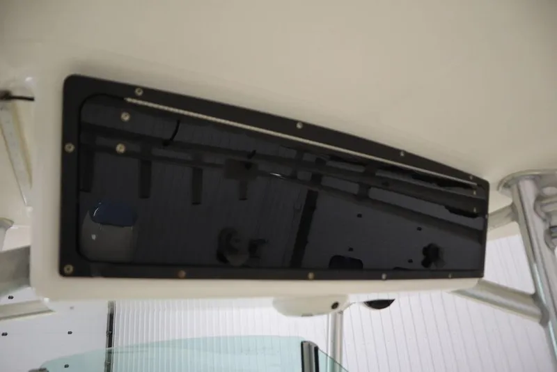 Slide: The Image of 2017 Mako 284 CC boat console with black panel and screws. - 40