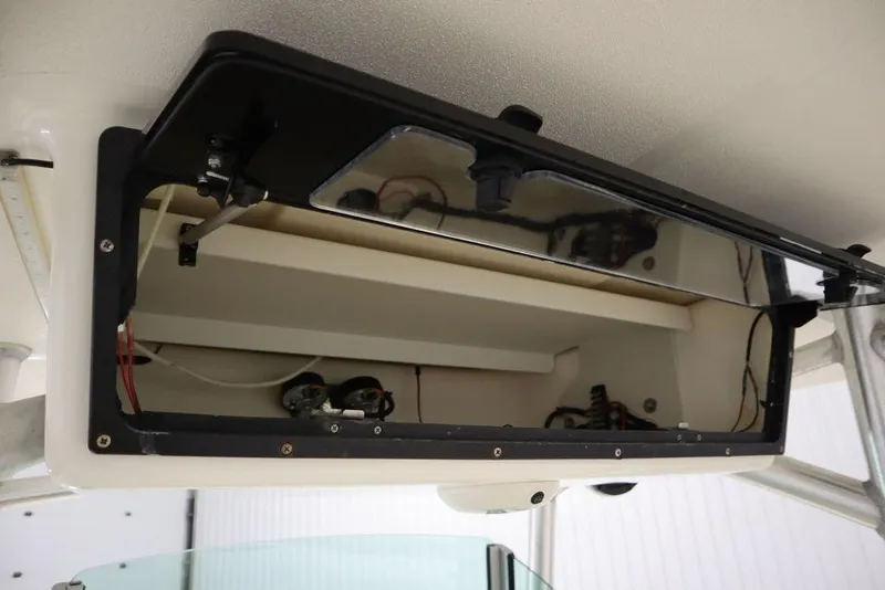 Slide: The Image of Open storage compartment on a 2017 Mako 284 CC boat. - 41