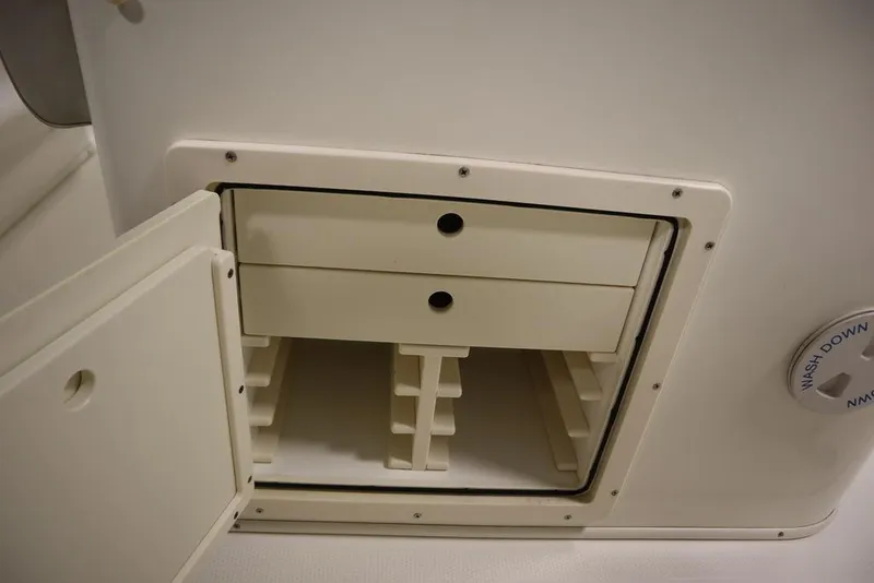 Slide: The Image of Open storage compartment with drawers on a 2017 Mako 284 CC boat. - 43