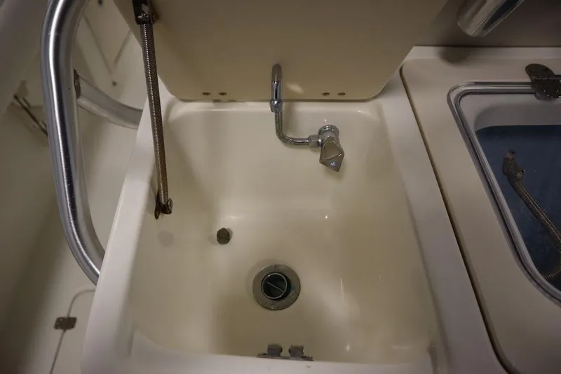 Slide: The Image of 2017 Mako 284 CC boat sink with faucet and drain. - 45