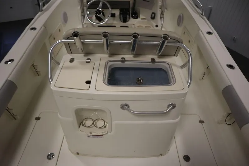 Slide: The Image of 2017 Mako 284 CC boat interior with rod holders and storage compartments. - 46