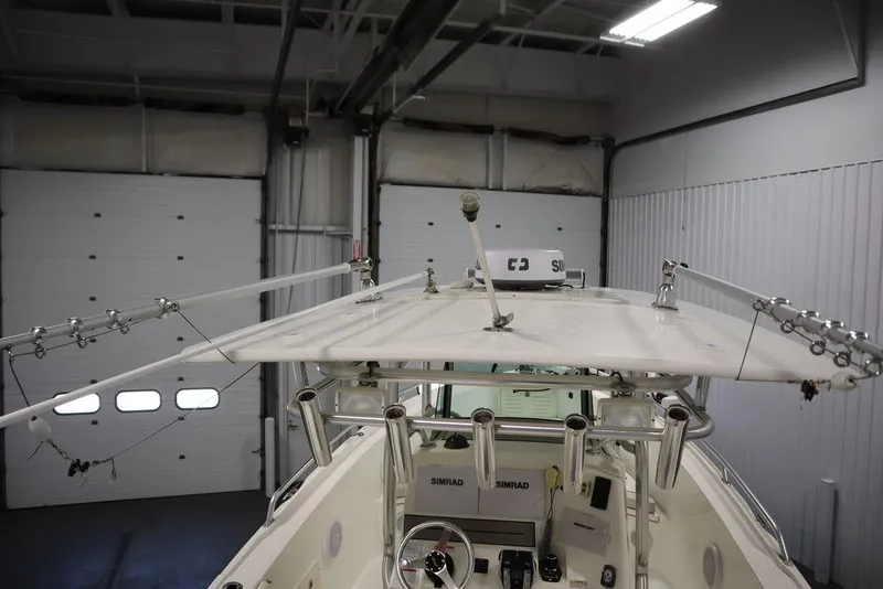 Slide: The Image of 2017 Mako 284 CC boat interior with fishing rod holders and navigation equipment. - 48