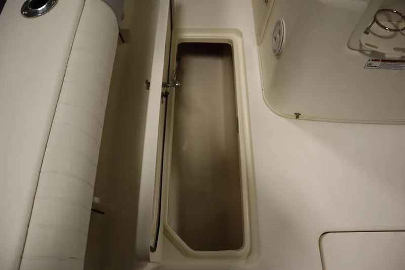 Slide: The Image of Open storage compartment on a 2017 Mako 284 CC boat. - 49