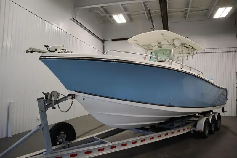 Slide: The Image of 2017 Mako 284 CC boat on trailer in indoor storage facility. - 7