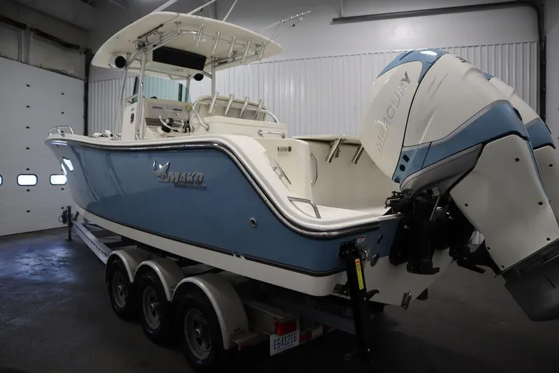 Slide: The Image of 2017 Mako 284 CC boat with Mercury outboard engine in indoor storage. - 8