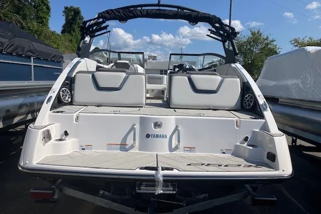 Slide: The Image of 2021 Yamaha Boats 252XE, rear view, showcasing sleek design and spacious seating. - 17